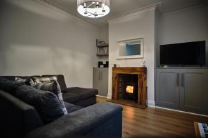 a living room with a couch and a fireplace at Halifax Haven – Simple2let Serviced Apartments in Halifax