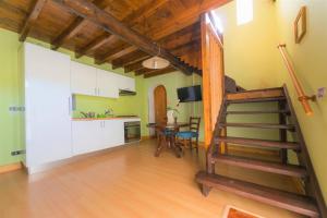 a kitchen and a staircase in a room with a table at Baglio Sciacca - Xenia Sicily Villas in Mazara del Vallo