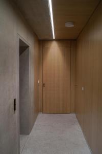 an empty hallway with wooden walls and a door at Castle View Luxury Suite in Ljubljana