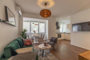a living room with a couch and a table at Sunset Beach Apartment in Zadar