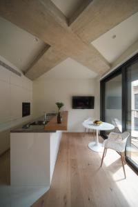 a kitchen with a table and a white counter top at Castle View Luxury Suite in Ljubljana