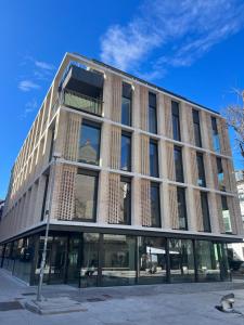 a large brick building with windows on a street at Castle View Luxury Suite in Ljubljana