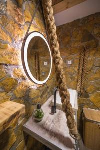 a stone bathroom with a mirror and a sink at Onore dell'amore 2 in Banja Koviljača