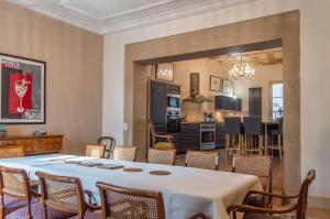 a kitchen and dining room with a table and chairs at Luxurious Character House in the Heart of Roujan in Roujan