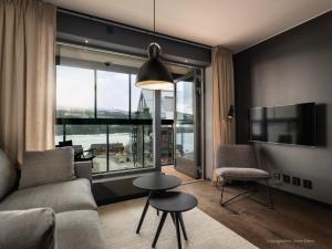 a living room with a couch and a large window at Stunning Apartment in View Are Ski in - VM8 Lift in Åre