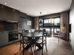 a kitchen and dining room with a table and chairs at Stunning Apartment in View Are Ski in - VM8 Lift in Åre