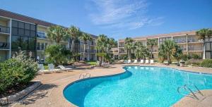 a large swimming pool in front of a building at Biloxi Beach Condo-B in Biloxi
