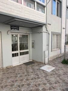 a building with a door with a sign on it at Lovely 2 bedroom vacation rental unit in Yalova