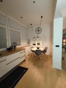 a kitchen with a table and a dining room at KELEIA NEW VILLAGE in Celje