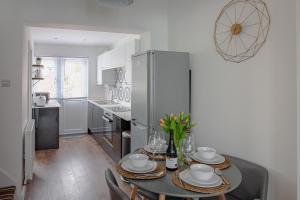 a kitchen and dining room with a table and chairs at Isca House, private garden, close to city center, the Quay, free wifi in Exeter