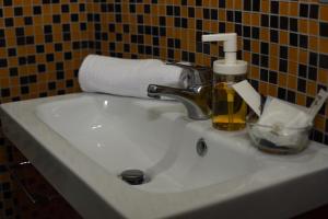 a sink with a soap dispenser and a roll of paper towels at Raggio di Luna in Valmontone