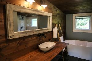 a bathroom with a sink and a bath tub at Modern Industrial Farmhouse - The Wayback in Orange