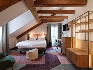 a hotel room with a bed and a desk at Hotel St. Josef in Zürich