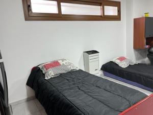a bedroom with two beds and a window at El Descanso Casa de retiro in Tandil +21 photos