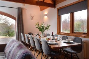 a dining room with a table and chairs at The Wilds - Seasgair Lodges in Kingussie