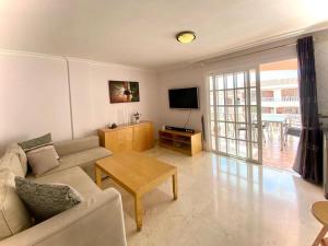 a living room with a couch and a table at Superior Apartment with Ocean View in Callao Salvaje