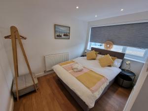 a bedroom with a bed and a large window at 28 ExcellentStays - Heathrow - 5 Bedroom House in Stanwell