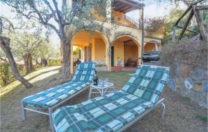 2 Stühle und ein Tisch vor einem Haus in der Unterkunft Stunning Home In Diano Calderina With 2 Bedrooms in Diano Castello