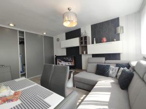 a living room with a couch and a table at Komfortowy Apartament w Kłodzku in Kłodzko