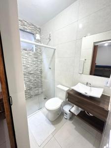a bathroom with a toilet and a sink and a shower at Pousada da Praia in Paraty +39 photos