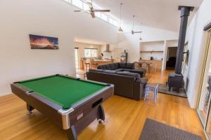 a living room with a pool table in it at Acacia Lakehouse in Goon Nure