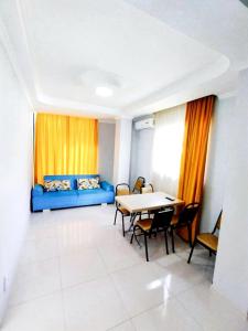 a room with a blue couch and a table and chairs at Dream House Ureki in Ureki +29 photos