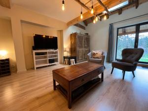 a living room with a coffee table and a tv at Spacious town house in the center of le Bourg d'Oisans in Le Bourg-dʼOisans