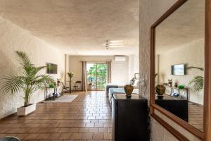 a hallway with a living room with a couch at Soy Local Puerto Vallarta in Puerto Vallarta