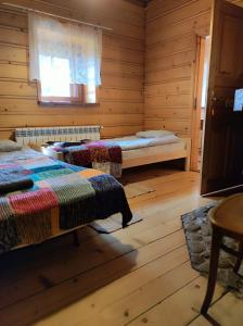 Postel nebo postele na pokoji v ubytování Gniazdo w Felicjanowie