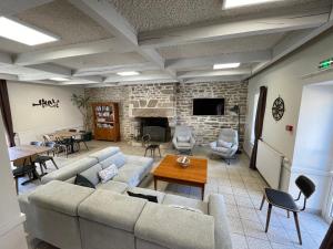 a living room with a couch and a fireplace at Gîte de Manehouarn in Plouay