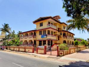 a yellow house on the side of a street at Sea View Resorts in Bogmalo