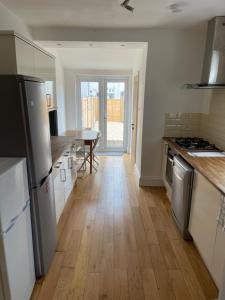 a kitchen with a wooden floor and a table at Room in Gloucester Road 4 in Bristol