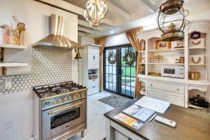 a kitchen with a stove and a counter top at New Smyrna Beach Cottage about 1 Mi to Downtown! in New Smyrna Beach