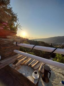 a bench with bats and a sunset in the background at Green Oasis 3 in Lámira