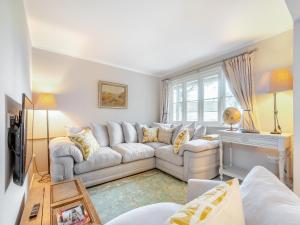 a living room with a white couch and a window at Pears Cottage - Uk43674 in Beckington