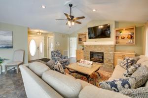 a living room with a couch and a fireplace at Stunning Lake Hamilton Getaway with Hot Tub! in Hot Springs