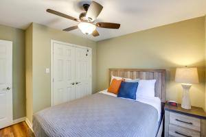 a bedroom with a bed with a ceiling fan at Stunning Lake Hamilton Getaway with Hot Tub! in Hot Springs +34 photos