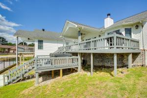 a house with a large deck on the side of it at Stunning Lake Hamilton Getaway with Hot Tub! in Hot Springs