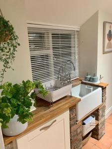 een keuken met twee wastafels en een groot raam bij Coney Cottage in Porthcawl