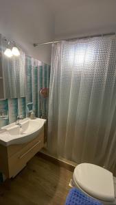 a bathroom with a sink and a shower curtain at Εξοχικό elia lakonias in Elia Laconias +38 photos