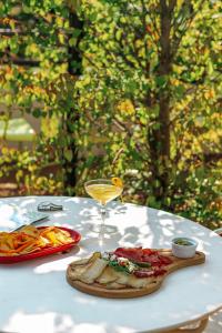 a table with a plate of food and a glass of wine at Collège Hôtel in Lyon