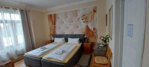a bedroom with a large bed in a room at Hotel Restaurant Mythos in Gelting +31 photos