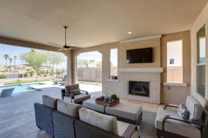 a living room with a couch and a fireplace at Goodyear Vacation Rental with Private Pool and Grill! in Goodyear