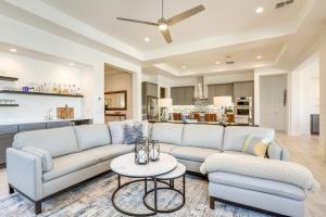 a living room with a couch and a table at Goodyear Vacation Rental with Private Pool and Grill! in Goodyear