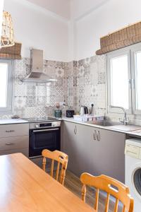 a kitchen with a wooden table and chairs in it at Galatia's House in Kouklia