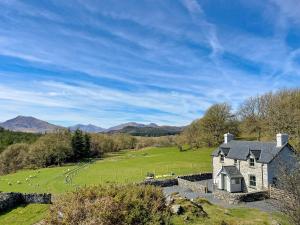 a house on a hill with a green field at Coed Mawr in Betws-y-coed