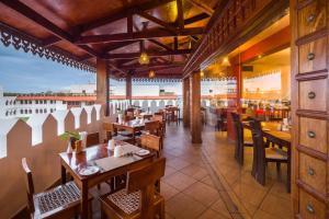 a restaurant with tables and chairs and a view at Spice Tree by Turaco in Zanzibar City