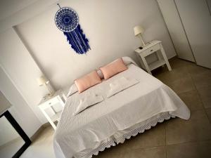 a bedroom with a bed and two night tables at TIERRA Alojamientos in Salta +54 photos