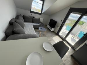 a living room with a couch and a table at Breathtaking View design apartment in Katerini