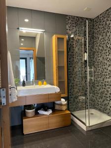 a bathroom with a sink and a shower at Crystal House in Angra do Heroísmo